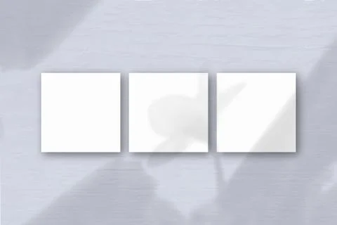 3 square sheets of white textured paper on the blue wall background. Mockup o Stock Illustration