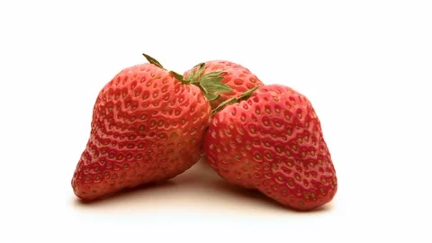 3 strawberries rotate on a white background Stock Footage 104050215