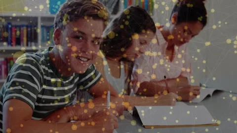 3 students studying as camera pulling left student glancing, yellow node overlay Video stock 331197521