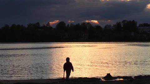 3. At sunset, a boy plays with sand Stock Footage 133960872