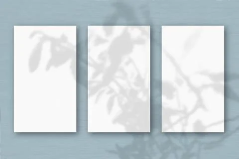 3 vertical sheets of textured white paper on soft gray table background. Mock Stock Illustration