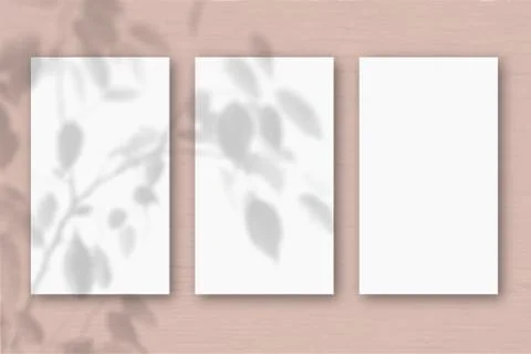 3 vertical sheets of textured white paper on soft peach table background. Moc Stock Illustration