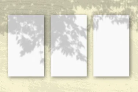 3 vertical sheets of textured white paper on soft yellow table background. Mo Stock Illustration