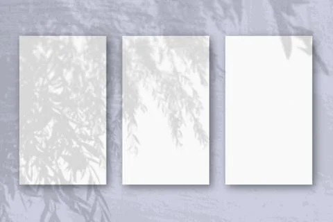 3 vertical sheets of textured white paper on soft blue table background. Mock Stock Illustration