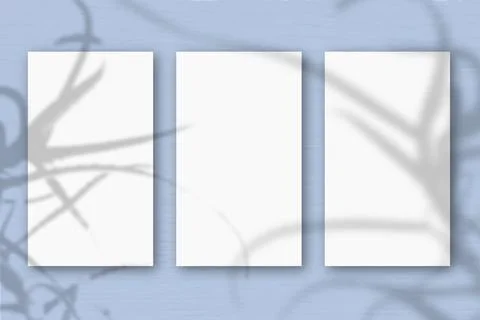3 vertical sheets of textured white paper on soft blue table background.Mocku Stock Illustration
