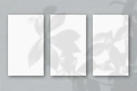 3 vertical sheets of textured white paper on soft gray table background. Mock Stock Illustration