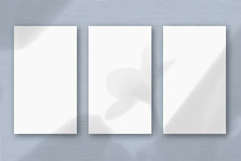 3 vertical sheets of textured white paper on soft gray table background. Mock Stock-Illustration