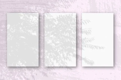 3 vertical sheets of textured white paper on soft pink table background. Mock Stock Photos