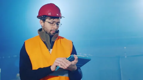 3 Video: builder or engineer in helmet working with the tablet Stock Footage 61811737