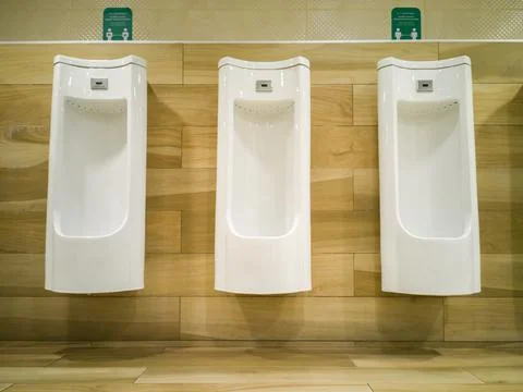 3 White urinal. Floor standing. With sensor. Fotos de archivo