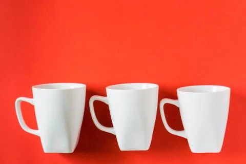 3 white winter coffee cup mugs lined up in a row for a break time meeting; Co Stock Photos