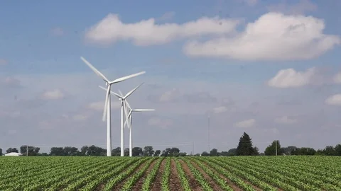 3 wind turbines left side in green row-crop Stock Footage 104516237