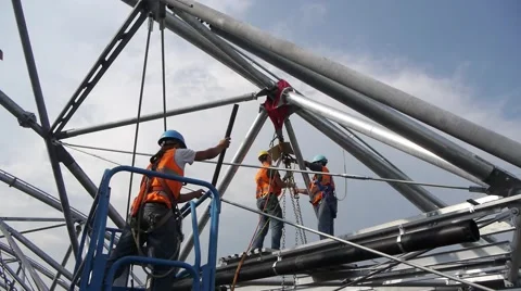3 workers in high visibility jackets at work on roof Stock Footage 46139507