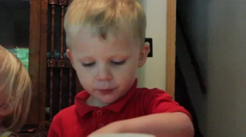 3 year old eats food with his fingers Stock Footage 40029224