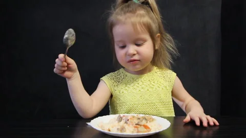 3 year old girl talking while eating Stock Footage 111332653