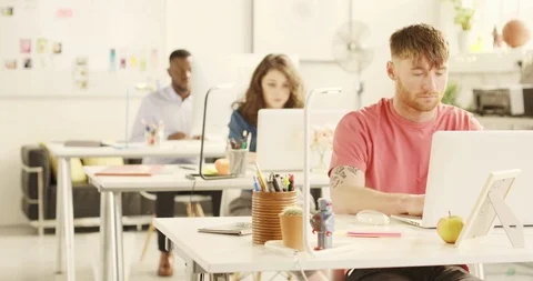 3 Young adults working in startup office. Rack focus Stock Footage 92186132