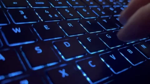 30 seconds of hand typing on back lit keyboard Stock Footage 233082508