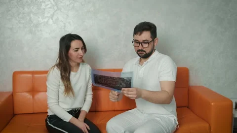 A 30-year-old dentist man sitting talking to a Caucasian patient on the couch Stock Footage 150590953