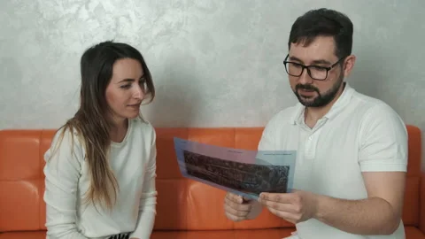 A 30-year-old dentist man sitting talking to a Caucasian patient on the couch Stock Footage 150614484