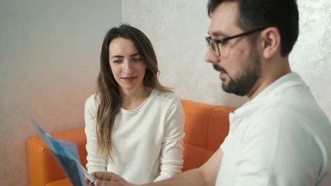 A 30-year-old dentist man sitting talking to a Caucasian patient on the couch Stock Footage 150647610
