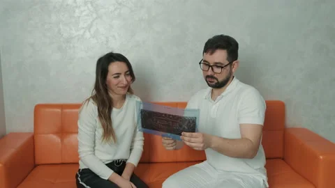 A 30-year-old dentist man sitting talking to a Caucasian patient on the couch Stock Footage 150828518