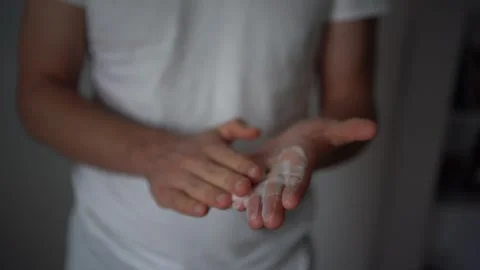 30-year-old man applies foam for washing on his skin Stock Footage 294523850