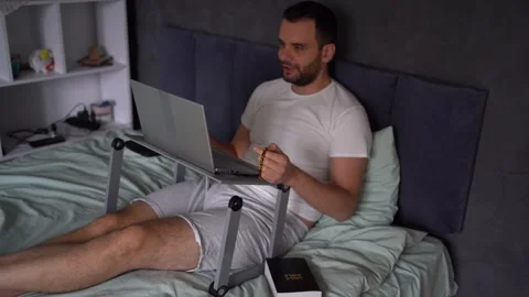 30-year-old man with a Bible attends an online church service, talks with t.. Stock Footage 294520901