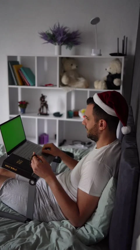 A 30-year-old man with a Bible attends an online church service, talks with.. Stock Footage 294524501