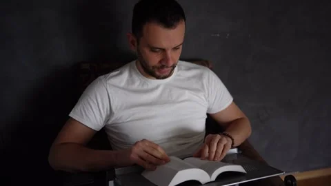 A 30-year-old man reads the Bible and prays in bed, morning routine Stock Footage 294522933