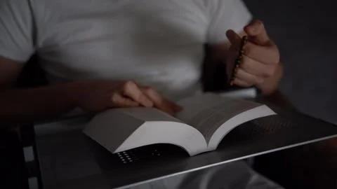 A 30-year-old man reads the Bible and prays in bed, morning routine Stock Footage 294522949