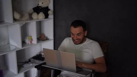 30-year-old man is stressed while working on a laptop from his home office Stock Footage 294523504