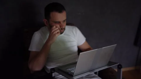 30-year-old man is stressed while working on a laptop from his home office Stock Footage 294523977