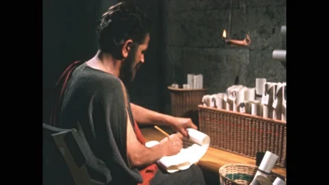300s BC: Aristotle writes on scroll, stops to think. Stock Footage 165357089