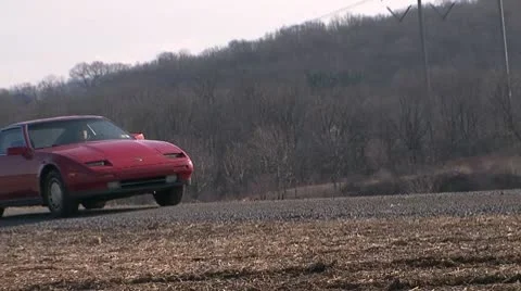 300zx CU through puddle Stock Footage 10582936