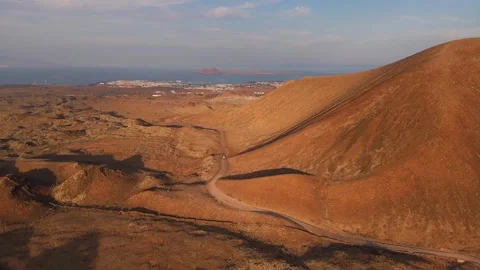 Following Road Through Volcanes de Bayuyo at Sunset Towards Corralejo