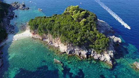 30fps 4K Aerial view of a small island surrounded by turquoise water Corfu Stock Footage 135390769