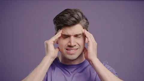 30S Aged Man Having Headache, Touching Temples, Suffering On Violet Background. Stock Footage 323139914