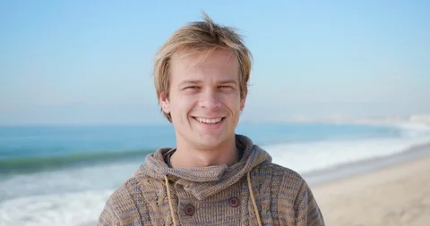 30's man portrait smiling at beach Stock Footage 127453385
