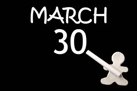 30th day of March. A small white plasticine man writing the date 30 March on  Stock Photos