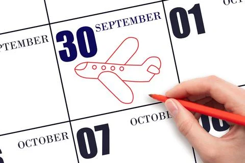 30th day of September. A hand drawing outline of airplane on calendar date 30 Stock Photos