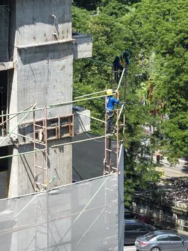 30th July 2017, workers work on high area in Bangkok Stock Photos
