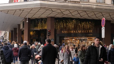 32 Rainy gray winter day Paris Lafayette Gallery entrance people crowd walkin Stock Footage 100813370