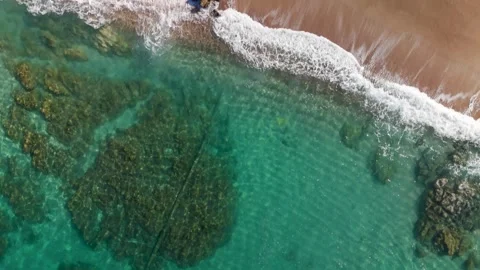 Aerial Top Down Shot of Turquoise Sea Meeting Golden Sand at Ruppione Beach