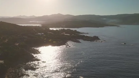 Aerial Flight Over Isoella Coastline Towards Golden Rising Sun