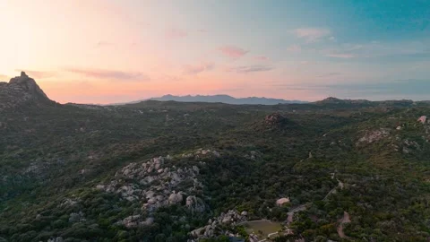 Drone Rising Over Lush Green Rugged Landscape Behind Plage de Paragan Beach