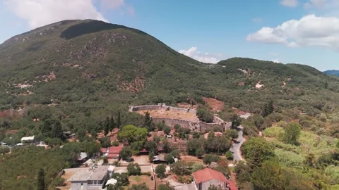 Drone Approach to Gardiki Castle Ruins with Lush Mountain Backdrop Drone Approach to Gardiki Castle Ruins with Lush Mountain Backdrop