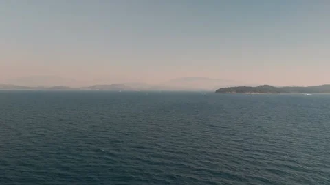 Aerial Flight Over Ionian Sea off Kassiopi Coast Towards Mainland Horizon Aerial Flight Over Ionian Sea off Kassiopi Coast Towards Mainland Horizon