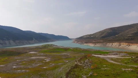 Aerial Wide Flight Over Winter Hills Towards Kouris Dam Reservoir, Cyprus