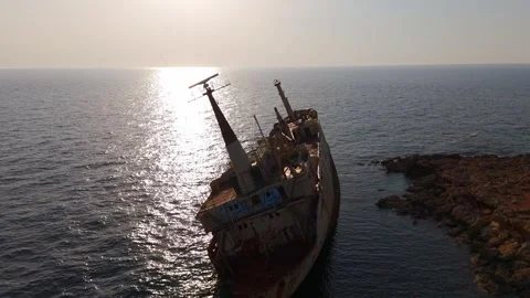 Aerial Flyover of Edro III Shipwreck at Sunset in Cyprus, Golden Hour Light