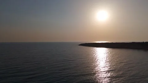 Cinematic Drone Flight Out to Sea, Hazy Golden Hour Coastline Silhouette, Cyprus